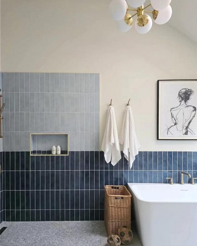 A vibrant bathroom showcasing polished blue ceramic tiles and shadow hexagon mosaic accents.
